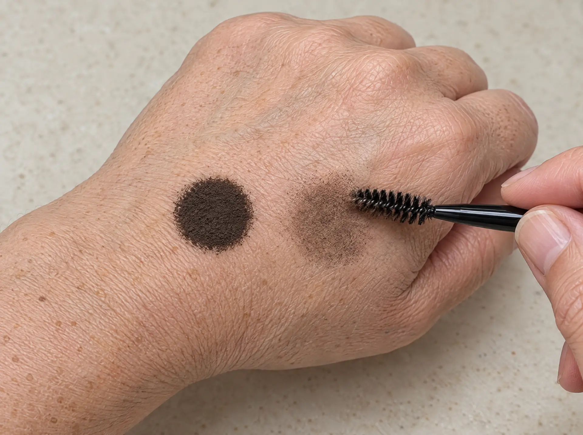 Stamp swatch on the hand, one dot blended out with the brush